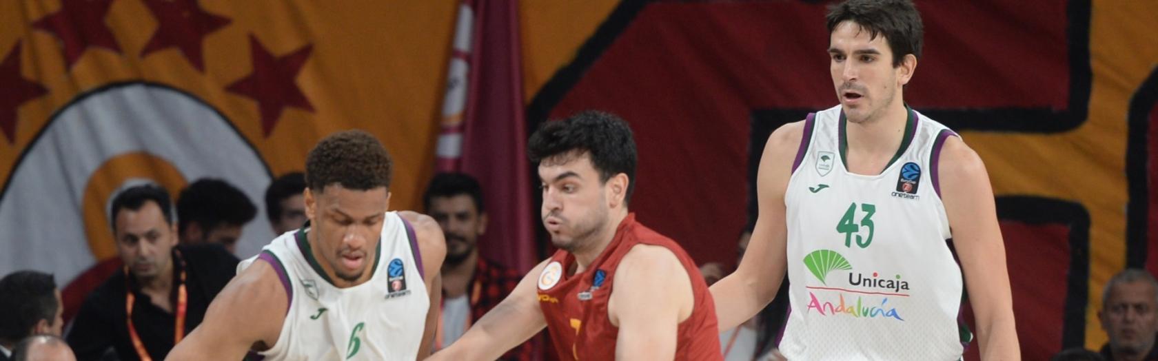 Axel Toupane lucha por un balón ante la mirada de Carlos Suárez